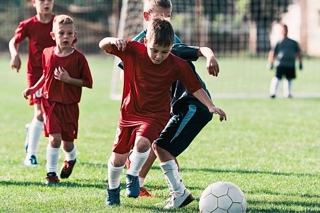 Young-footballer-dribbles-football4football
